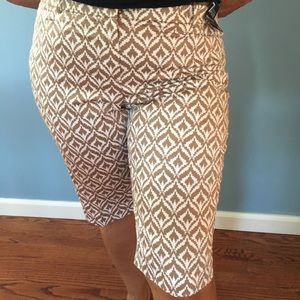 Tan and white Bermuda shorts.